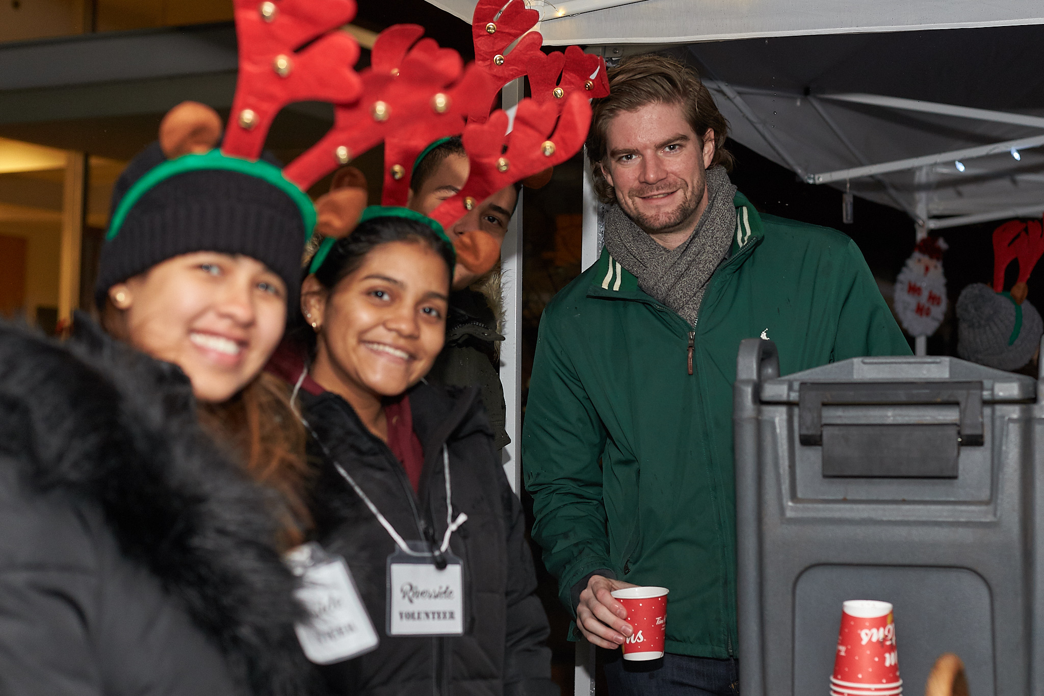 Dylan Luft of Baird MacGregor (at left) Serving up Hot Chocolate with volunteers at Light Up Riverside