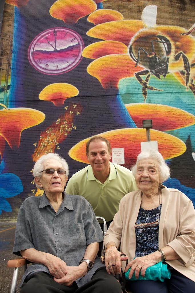 Albert and Ruth Edelstein pictured with Riverside BIA Chair Mitch Korman in 2016 at the launch of the Riverside Pollinator Mural by artist Nick Sweetman which pays homage to Albert's time with the BIA (Photo by Riverside BIA)