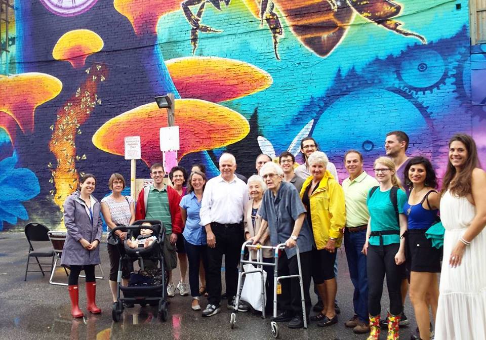 Caption: MP Julie Dabrusin, MPP Peter Tabuns and City Councillor Paula Fletcher stand with Riverside community members including Riverside BIA Board chair Mitch Korman and Executive Director Jennifer Lay.