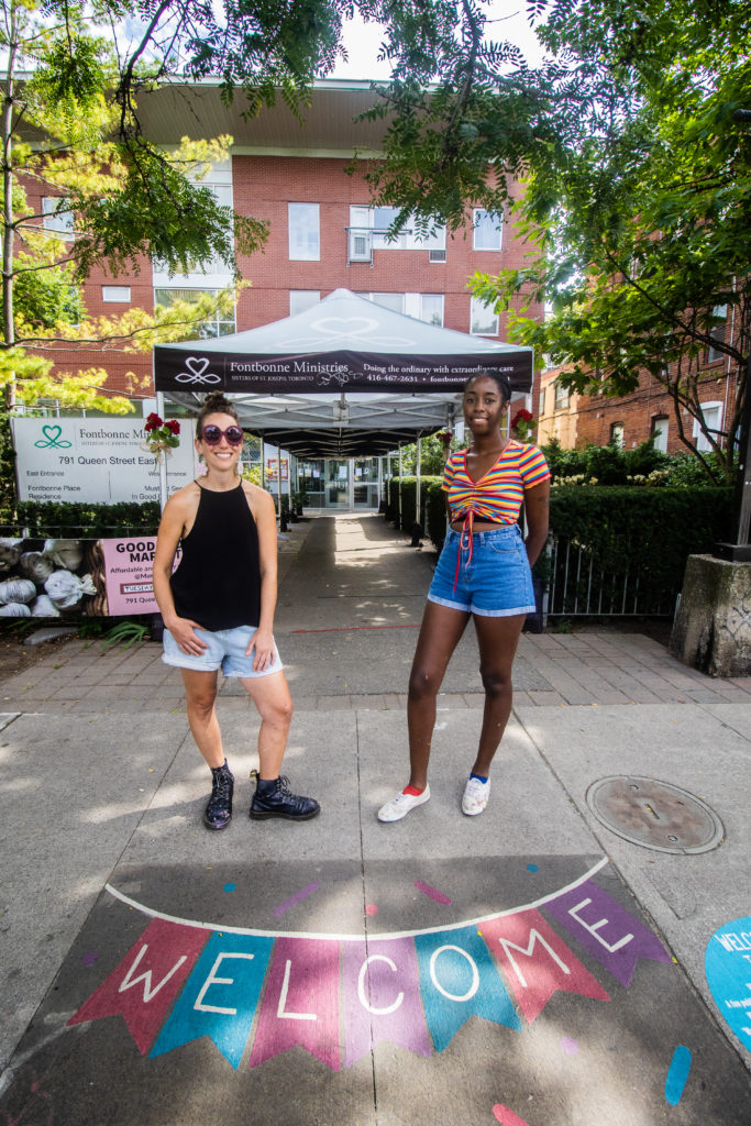 Mural artists Bareket Kezwer and Curtia Wright pose with Welcome Back to Main Street sidewalk art by Bareket in front of 791 Queen St E - Photo Credit Selina McCallum