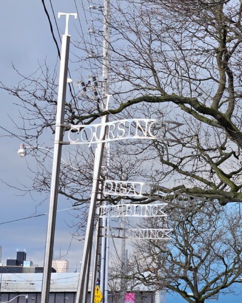Art on metal poles beside Jimmie Simpson Park in Toronto as part of the Riverside BIA project Time and A Clock art by Eldon Garnet in 1995